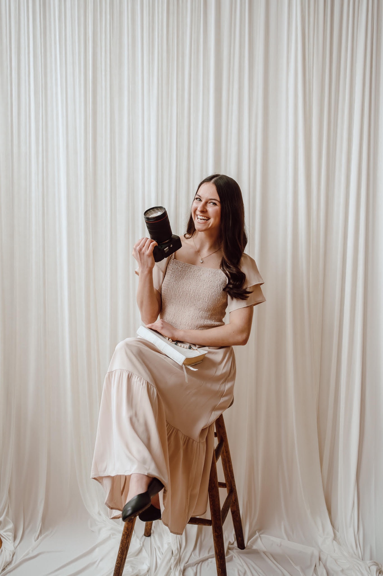 Emily, the photographer behind Lumen Dei Photo, with her camera