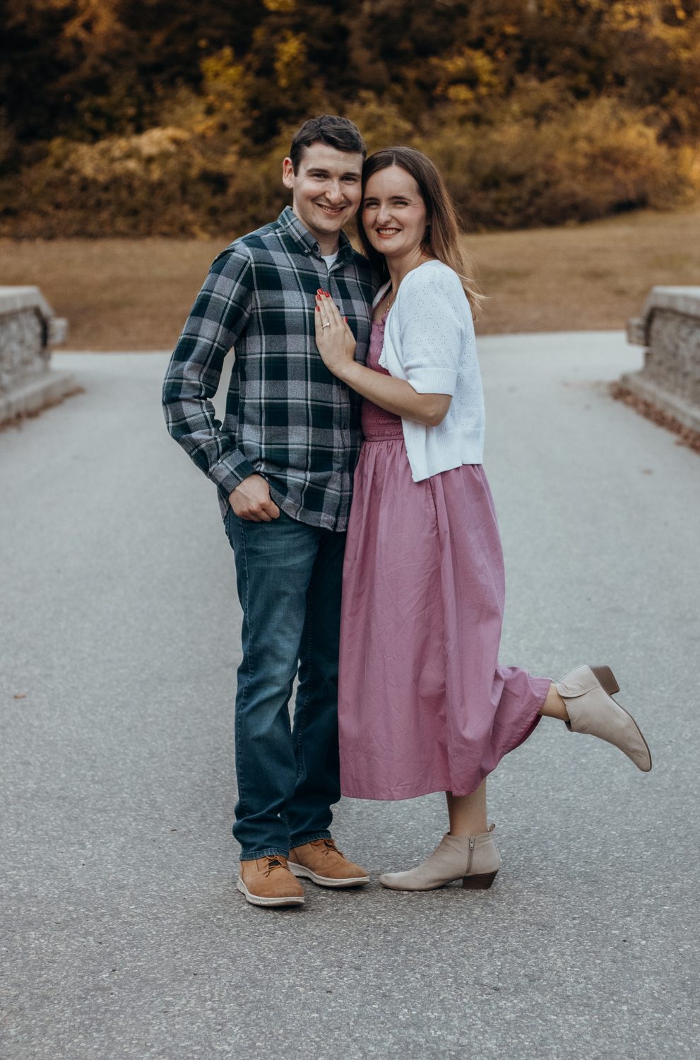 A couple laughing in an autumn field