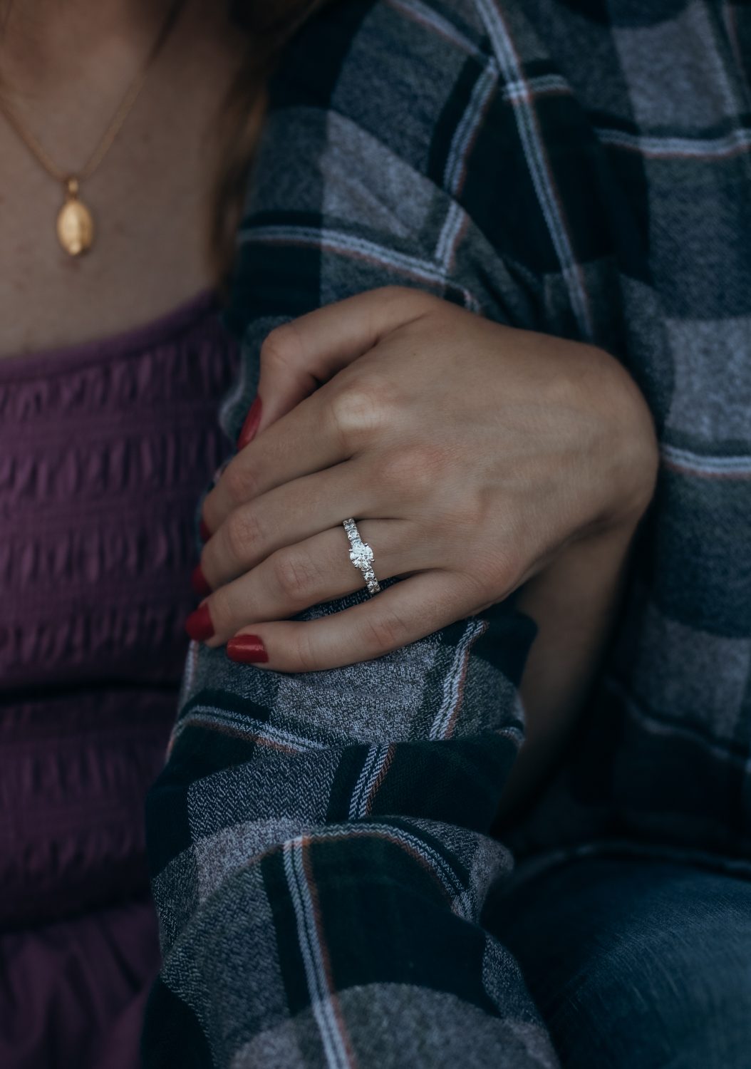 An engagement ring held to the light