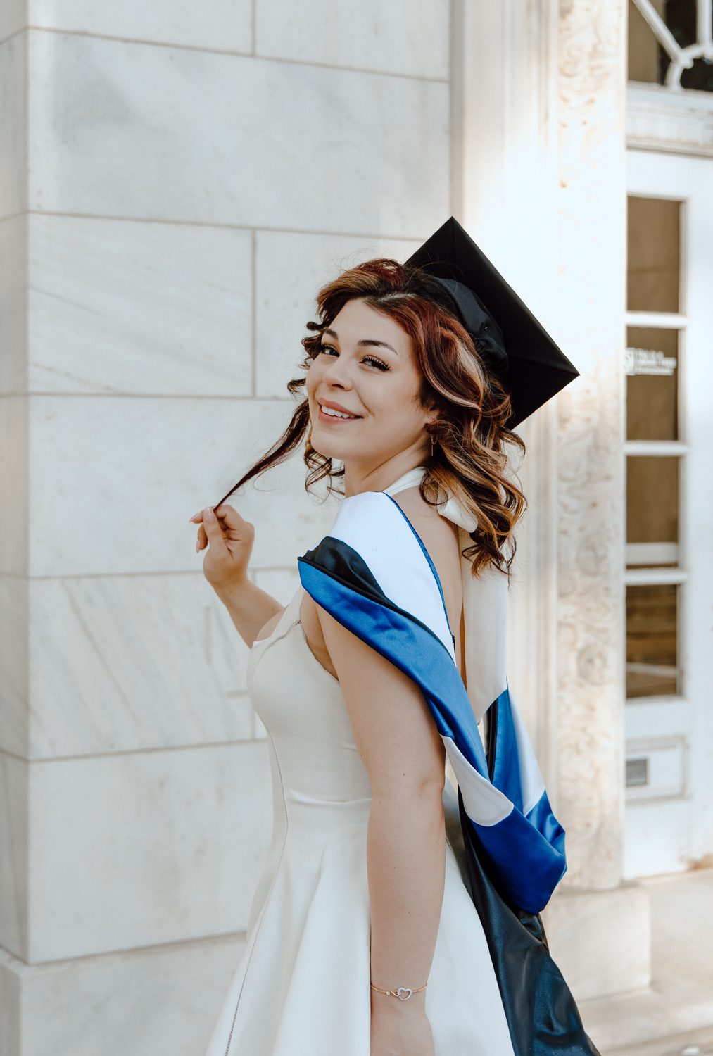 A graduate tossing her cap