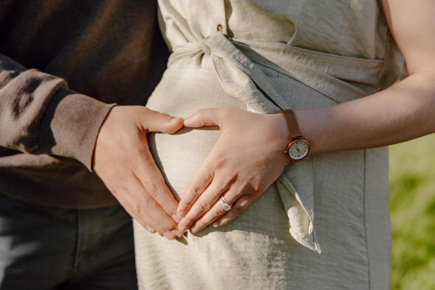 Hands resting on an expecting mother