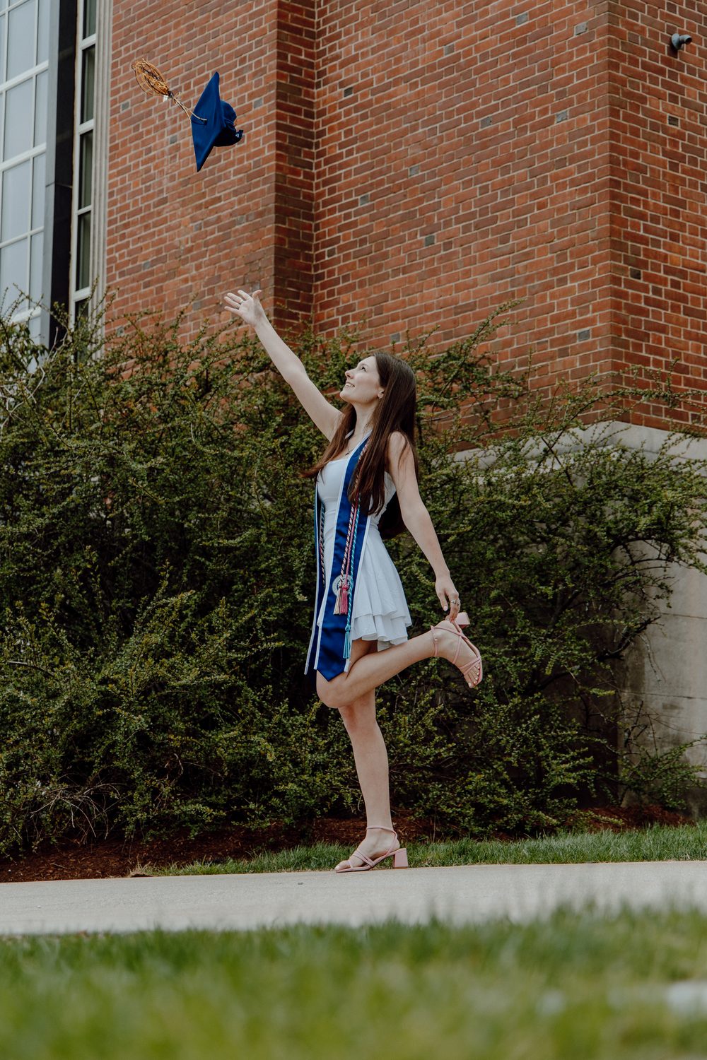 A graduate leaping for joy