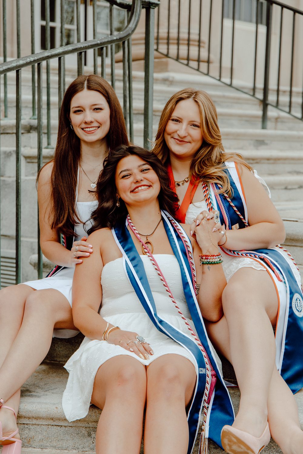 Graduates together on the steps